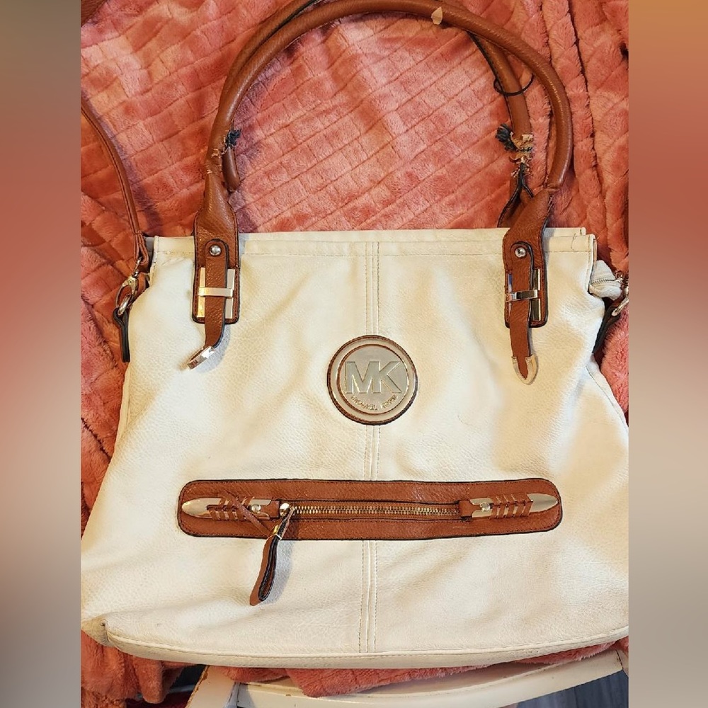 Michael Kors large tote bag, used, needs cleaning, has a few rips on the straps.
